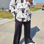 Shirt featuring a black and white geometric abstract print, a structured high half collar, and elongated double cuffs.