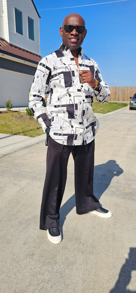 Shirt featuring a black and white geometric abstract print, a structured high half collar, and elongated double cuffs.