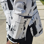 Shirt featuring a black and white geometric abstract print, a structured high half collar, and elongated double cuffs.