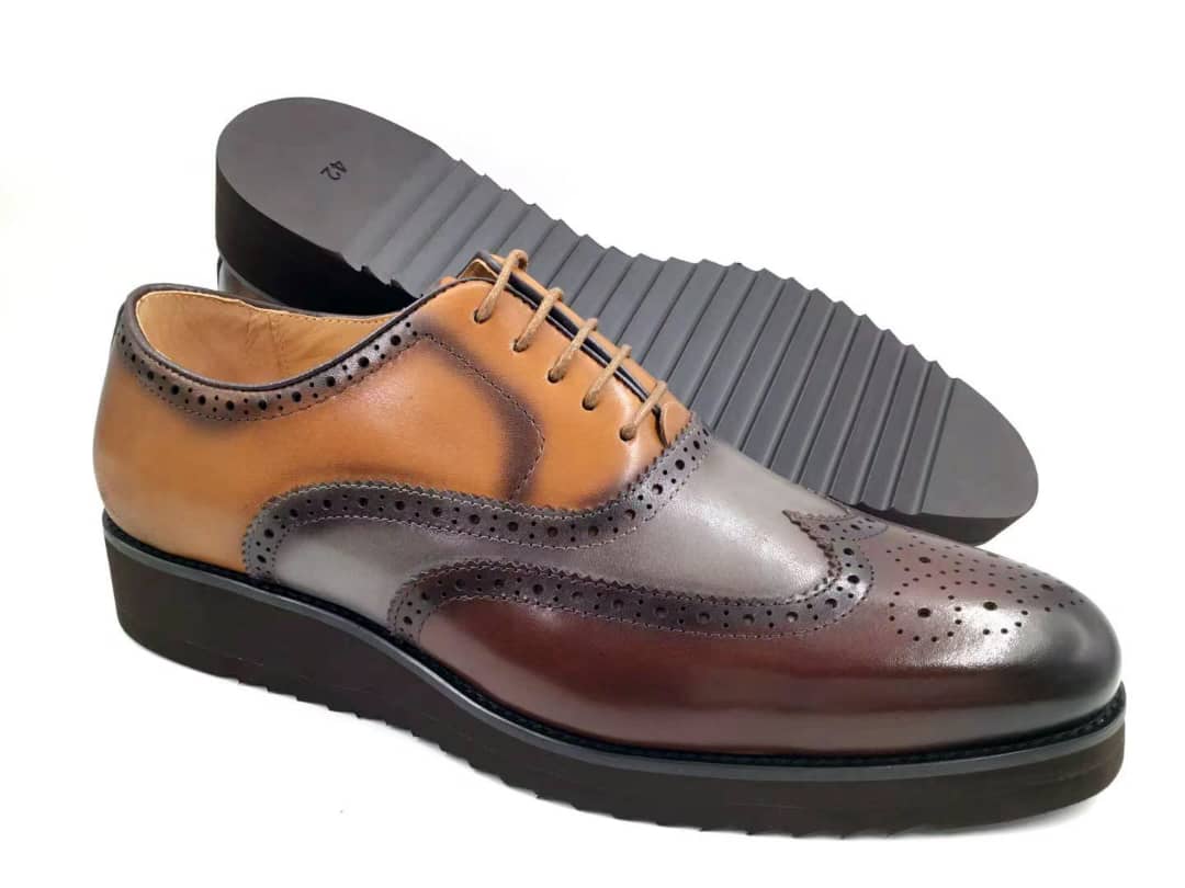 The Horizon Brogue Wingtip with its espresso, slate, and tan gradient leather upper, precision wingtip brogue detailing, and thick black rippled platform sole.
