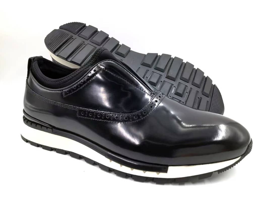 The Hybrid Brogue Runner with its high-shine black leather upper, traditional brogue perforations, black neoprene ankle collar, and a thick black and white high-traction sole.