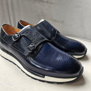 The Jigo Monk Double Monk Strap with its deep navy burnished leather, etched calligraphy on the double straps, and a contrasting white rugged outsole.