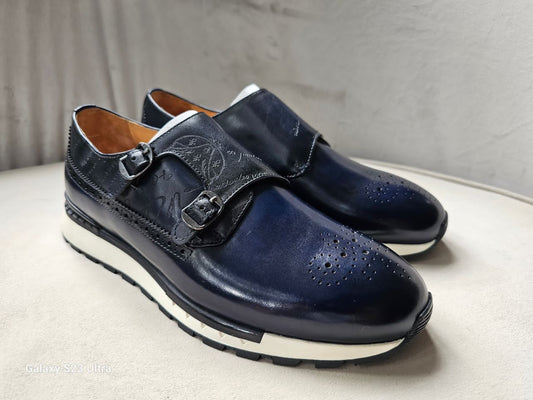 The Jigo Monk Double Monk Strap with its deep navy burnished leather, etched calligraphy on the double straps, and a contrasting white rugged outsole.