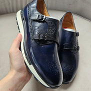 The Jigo Monk Double Monk Strap with its deep navy burnished leather, etched calligraphy on the double straps, and a contrasting white rugged outsole.