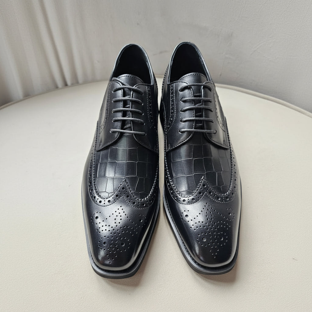 The Oba Wingtip with its multi-textured black leather design, croc-embossed vamps, and intricate wingtip brogue detailing.