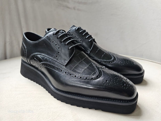 The Oba Wingtip with its multi-textured black leather design, croc-embossed vamps, and intricate wingtip brogue detailing.
