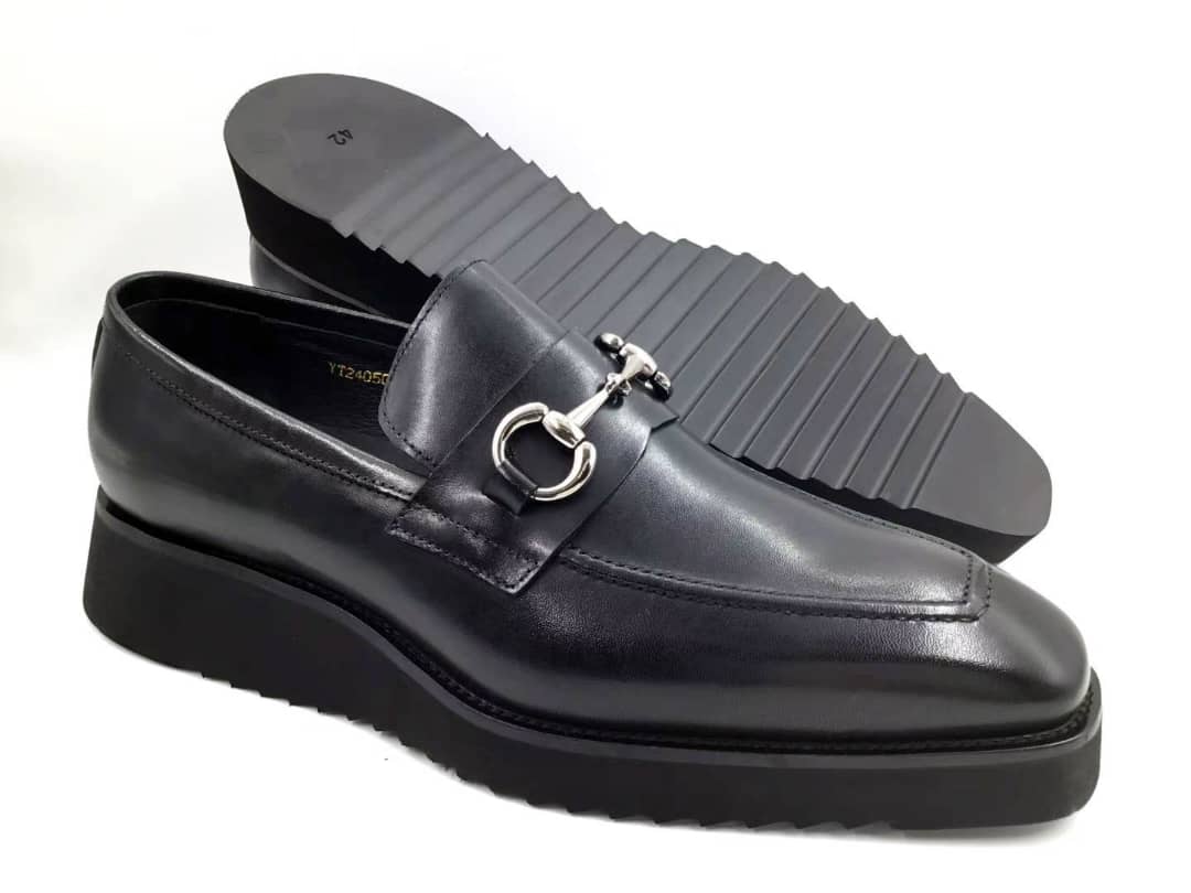Stealth Bit Loafer with its smooth black leather upper, silver-tone horsebit accent, and a thick, black architectural rippled sole.