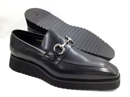 Stealth Bit Loafer with its smooth black leather upper, silver-tone horsebit accent, and a thick, black architectural rippled sole.