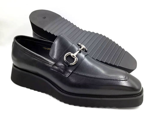 Stealth Bit Loafer with its smooth black leather upper, silver-tone horsebit accent, and a thick, black architectural rippled sole.
