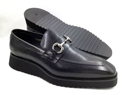 Stealth Bit Loafer with its smooth black leather upper, silver-tone horsebit accent, and a thick, black architectural rippled sole.