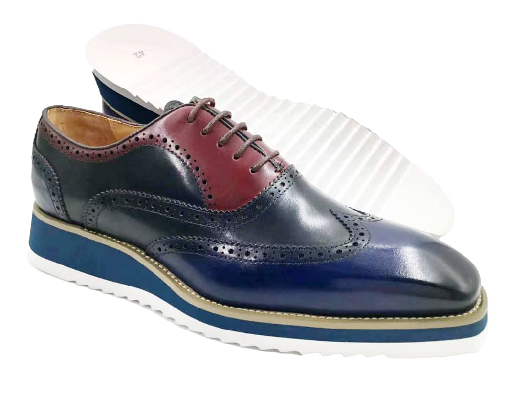 This hybrid dress shoe combines a traditional wingtip brogue upper with a contemporary white ripple sole. 