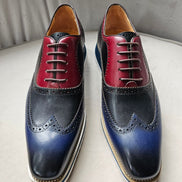 This hybrid dress shoe combines a traditional wingtip brogue upper with a contemporary white ripple sole. Featuring a bold midnight navy and rich burgundy leather construction