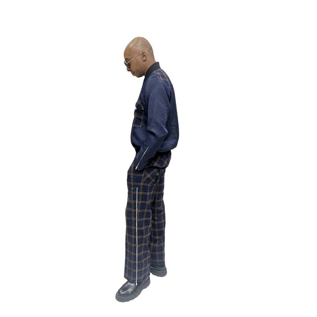 Tracksuit featuring a dark blue zip-up jacket with plaid pocket accents and matching plaid trousers with a side cargo pocket