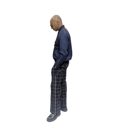 Tracksuit featuring a dark blue zip-up jacket with plaid pocket accents and matching plaid trousers with a side cargo pocket