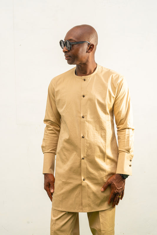 Traditional African outfit featuring a tan long-sleeved tunic with a round neckline, center-front button detailing, and matching structured trousers.