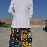 Trousers featuring a vibrant multi-colored geometric patchwork Ankara print in a dramatic wide-leg palazzo silhouette.