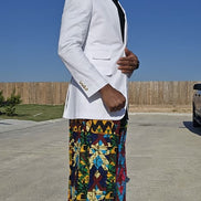 Trousers featuring a vibrant multi-colored geometric patchwork Ankara print in a dramatic wide-leg palazzo silhouette.