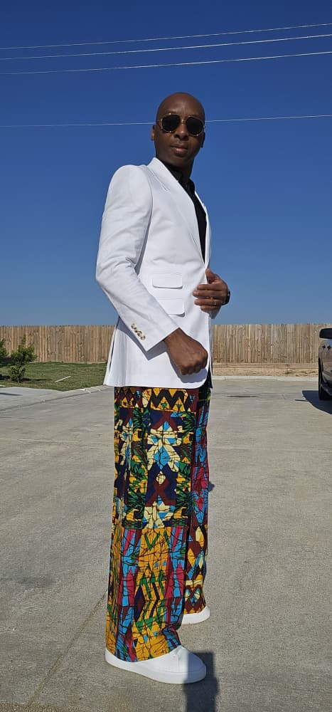 Trousers featuring a vibrant multi-colored geometric patchwork Ankara print in a dramatic wide-leg palazzo silhouette.