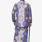 Two-Piece Set featuring a long-sleeved Ankara shirt and a matching traditional wrapper in a purple, silver, and black houndstooth pattern, finished with a black velvet collar and vertical chest placket