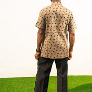 Two-Piece Set  featuring a short-sleeved patterned brown shirt with asymmetric buttons and coffee brown corduroy boot-cut trousers. Back View