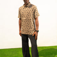 Two-Piece Set featuring a short-sleeved patterned brown shirt with asymmetric buttons and coffee brown corduroy boot-cut trousers.