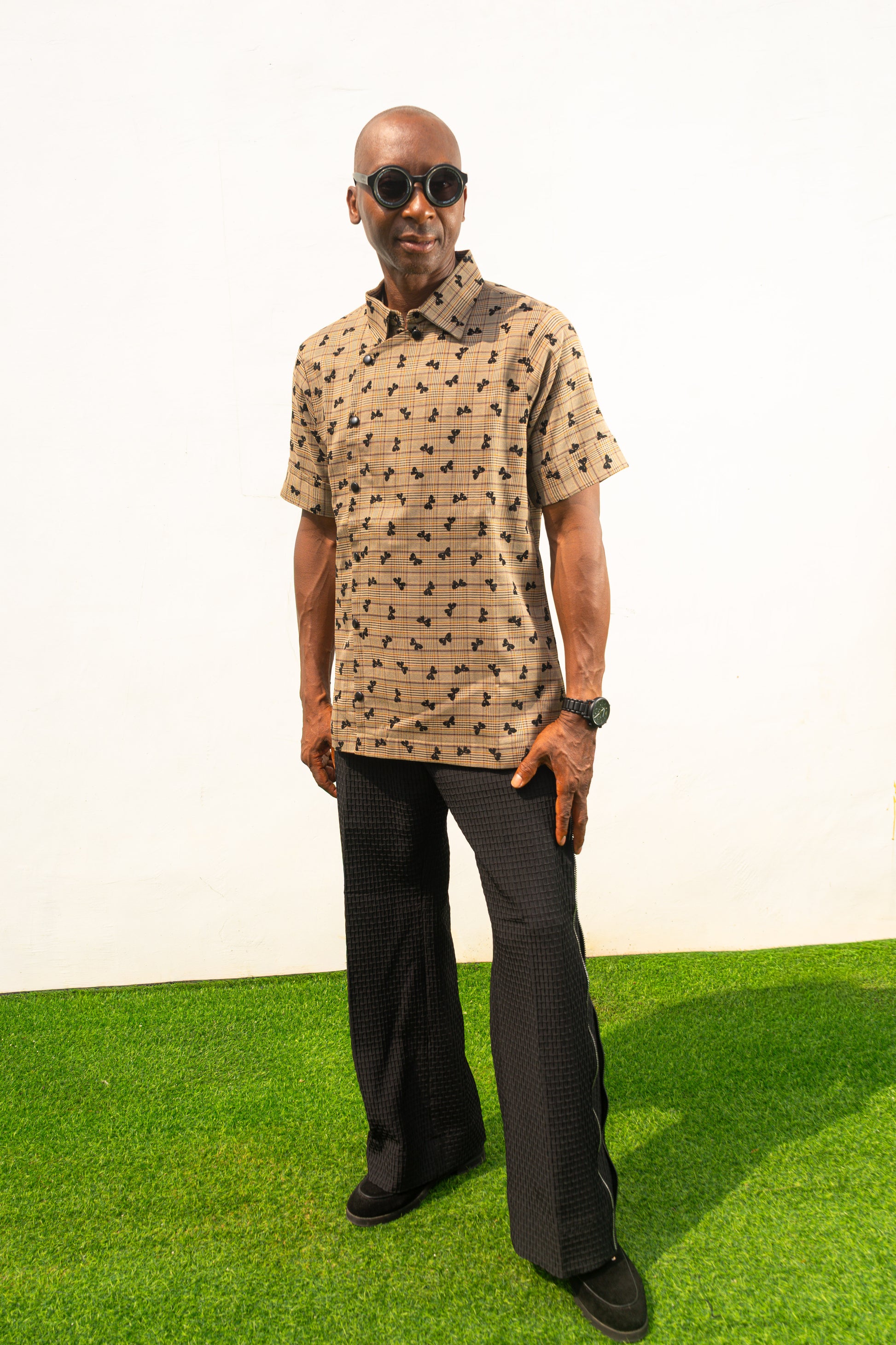 Two-Piece Set featuring a short-sleeved patterned brown shirt with asymmetric buttons and coffee brown corduroy boot-cut trousers.