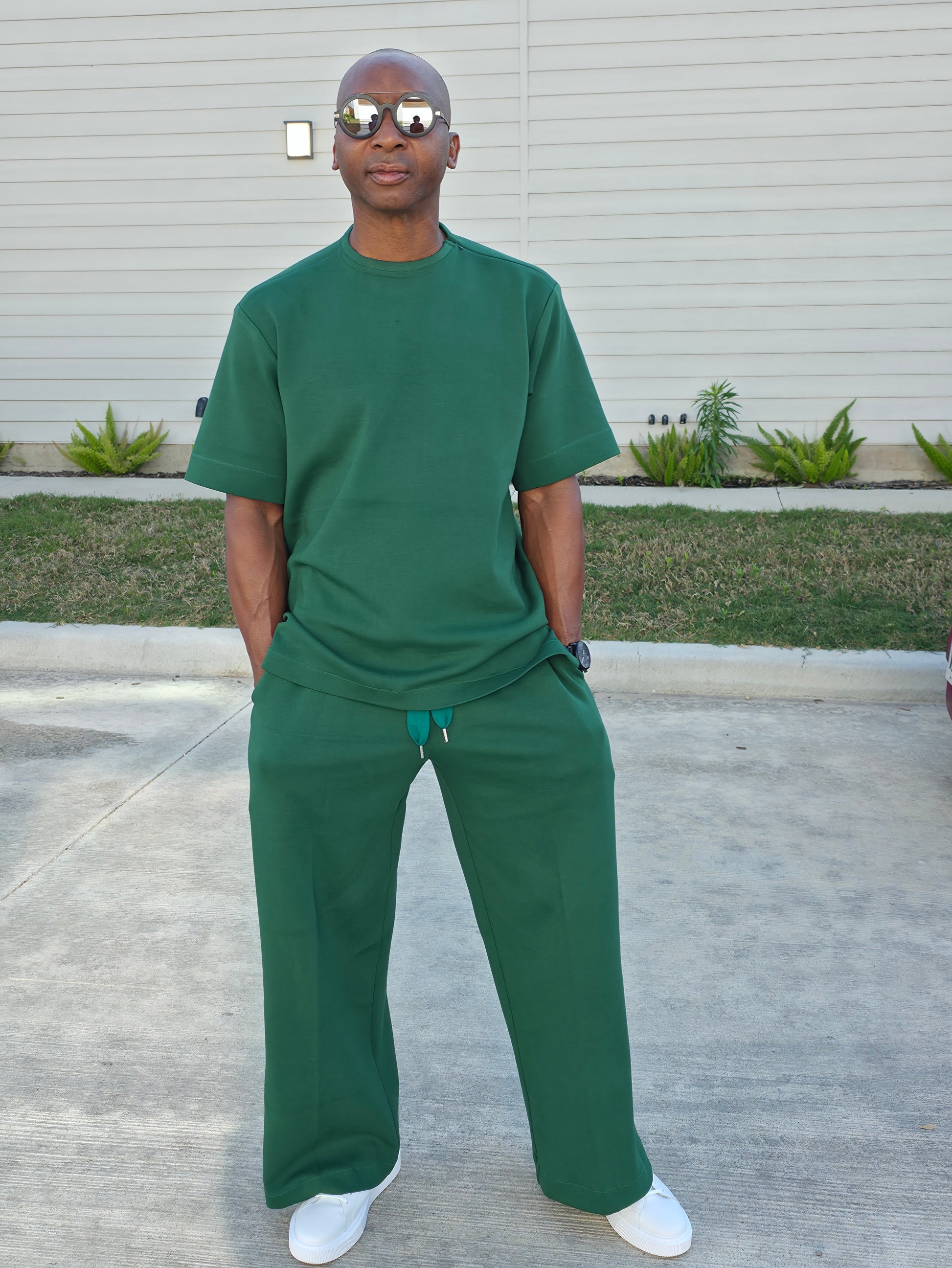 Forest emerald two-piece set featuring a boxy short-sleeved crewneck top and matching wide-leg trousers. -Front View
