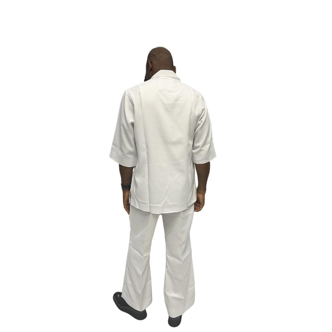 Two-Piece Set featuring a crisp white short-sleeved tunic top with a structured collar, metallic button detailing, and matching wide-leg trousers accented by an integrated fabric belt tie
