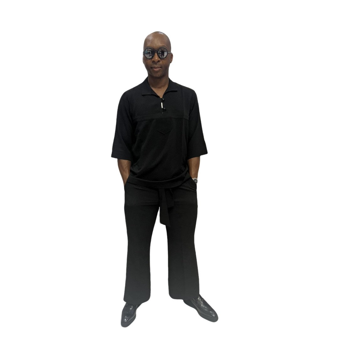 Two-Piece Set featuring a sleek black short-sleeved tunic shirt with a structured polo-style collar, subtle chest-panel stitching, and coordinating wide-leg trousers