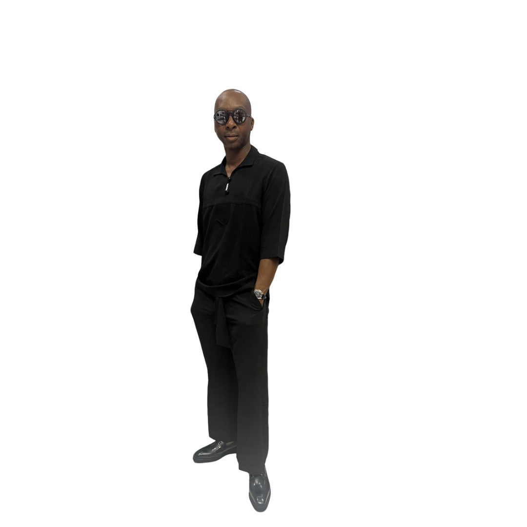 Two-Piece Set featuring a sleek black short-sleeved tunic shirt with a structured polo-style collar, subtle chest-panel stitching, and coordinating wide-leg trousers