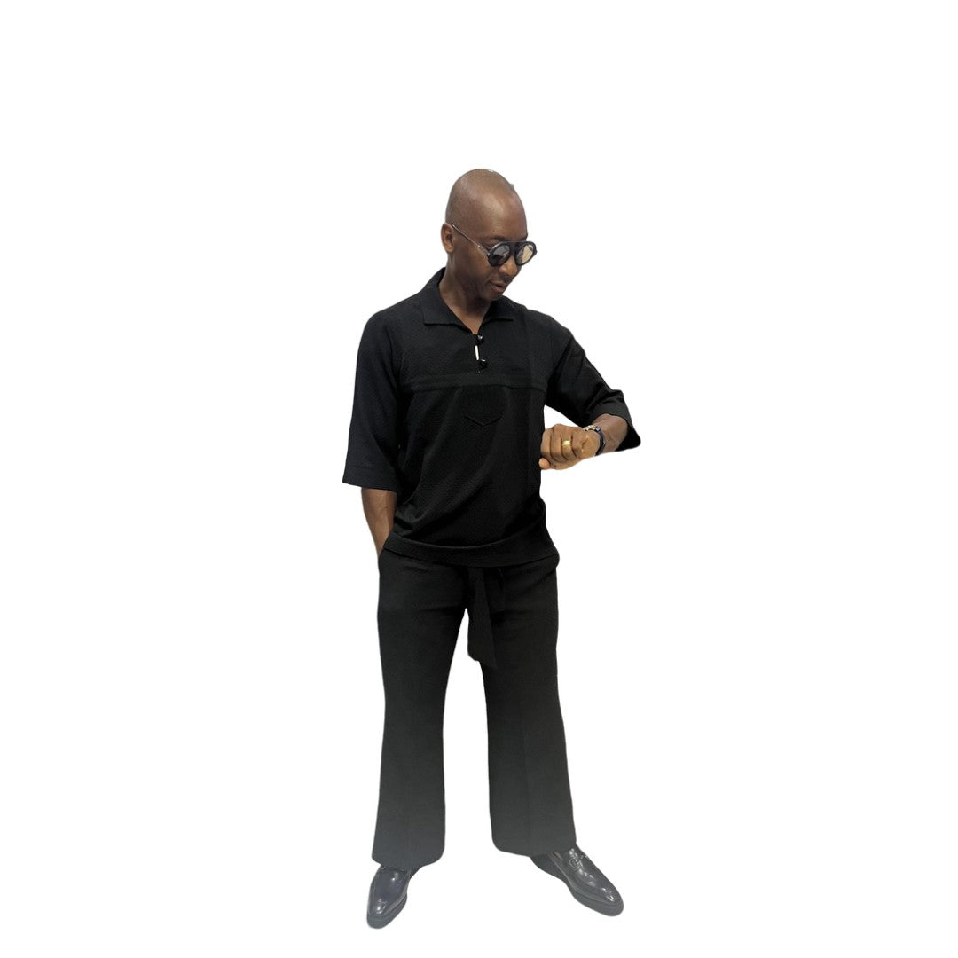 Two-Piece Set featuring a sleek black short-sleeved tunic shirt with a structured polo-style collar, subtle chest-panel stitching, and coordinating wide-leg trousers