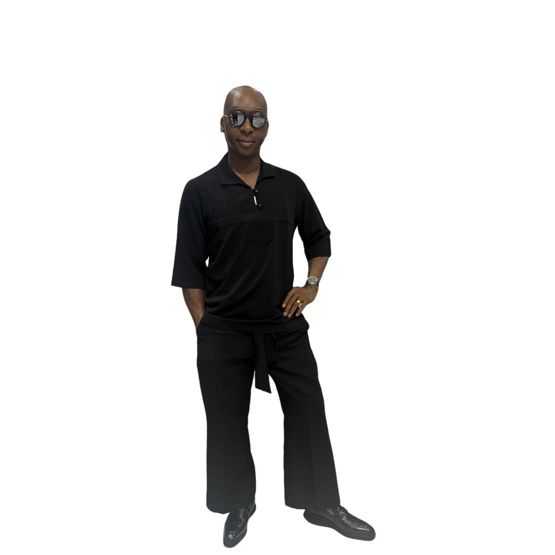 Two-Piece Set featuring a sleek black short-sleeved tunic shirt with a structured polo-style collar, subtle chest-panel stitching, and coordinating wide-leg trousers