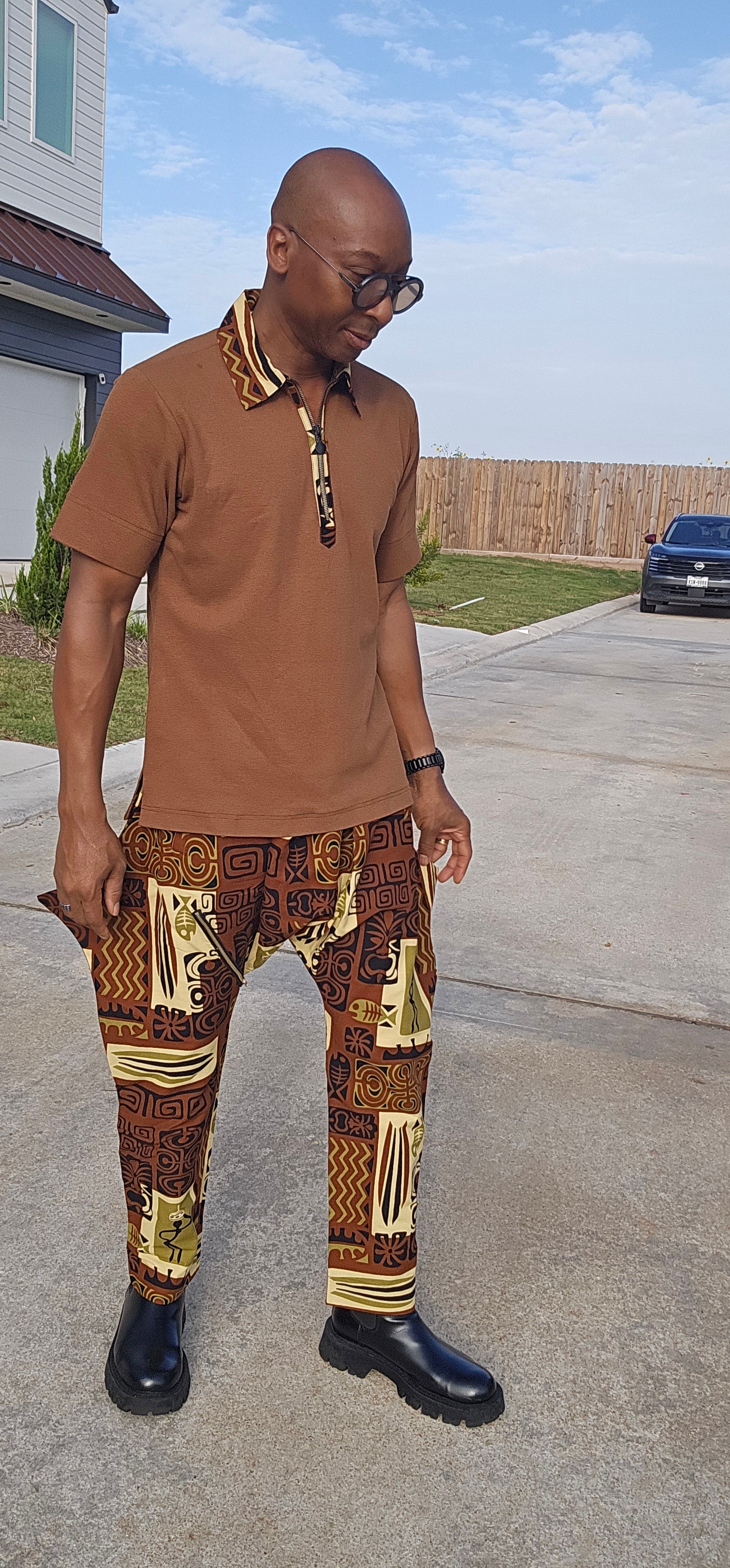 Two-Piece Set featuring a cognac brown short-sleeved polo with patterned collar trim and matching brown tribal print drop-crotch trousers.