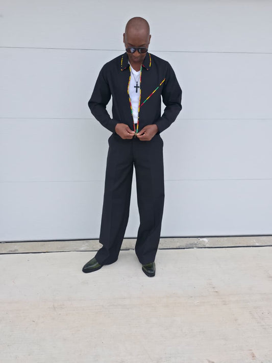 Two-Piece Set featuring a black virgin wool cropped zip-up jacket and wide-leg trousers accented by thin red, yellow, and green Ankara patterned piping.