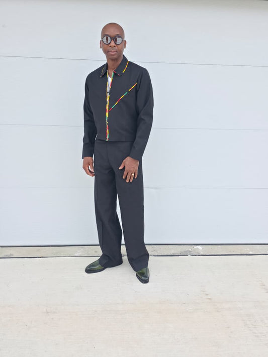 Two-Piece Set featuring a black virgin wool cropped zip-up jacket and wide-leg trousers accented by thin red, yellow, and green Ankara patterned piping.