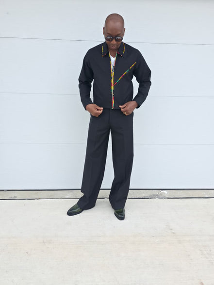 Two-Piece Set featuring a black virgin wool cropped zip-up jacket and wide-leg trousers accented by thin red, yellow, and green Ankara patterned piping.