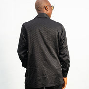 Two-Piece Set featuring a black textured viscose safari-style button-down shirt with four utility pockets and matching boot-cut trousers.