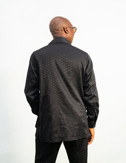 Two-Piece Set featuring a black textured viscose safari-style button-down shirt with four utility pockets and matching boot-cut trousers.