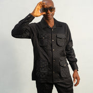 Two-Piece Set featuring a black textured viscose safari-style button-down shirt with four utility pockets and matching boot-cut trousers.