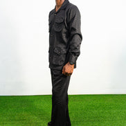 Two-Piece Set featuring a black textured viscose safari-style button-down shirt with four utility pockets and matching boot-cut trousers.
