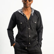 Two-Piece Set featuring a black hooded button-down shirt with zebra-print hood lining and matching black flared trousers with front-seam detailing.