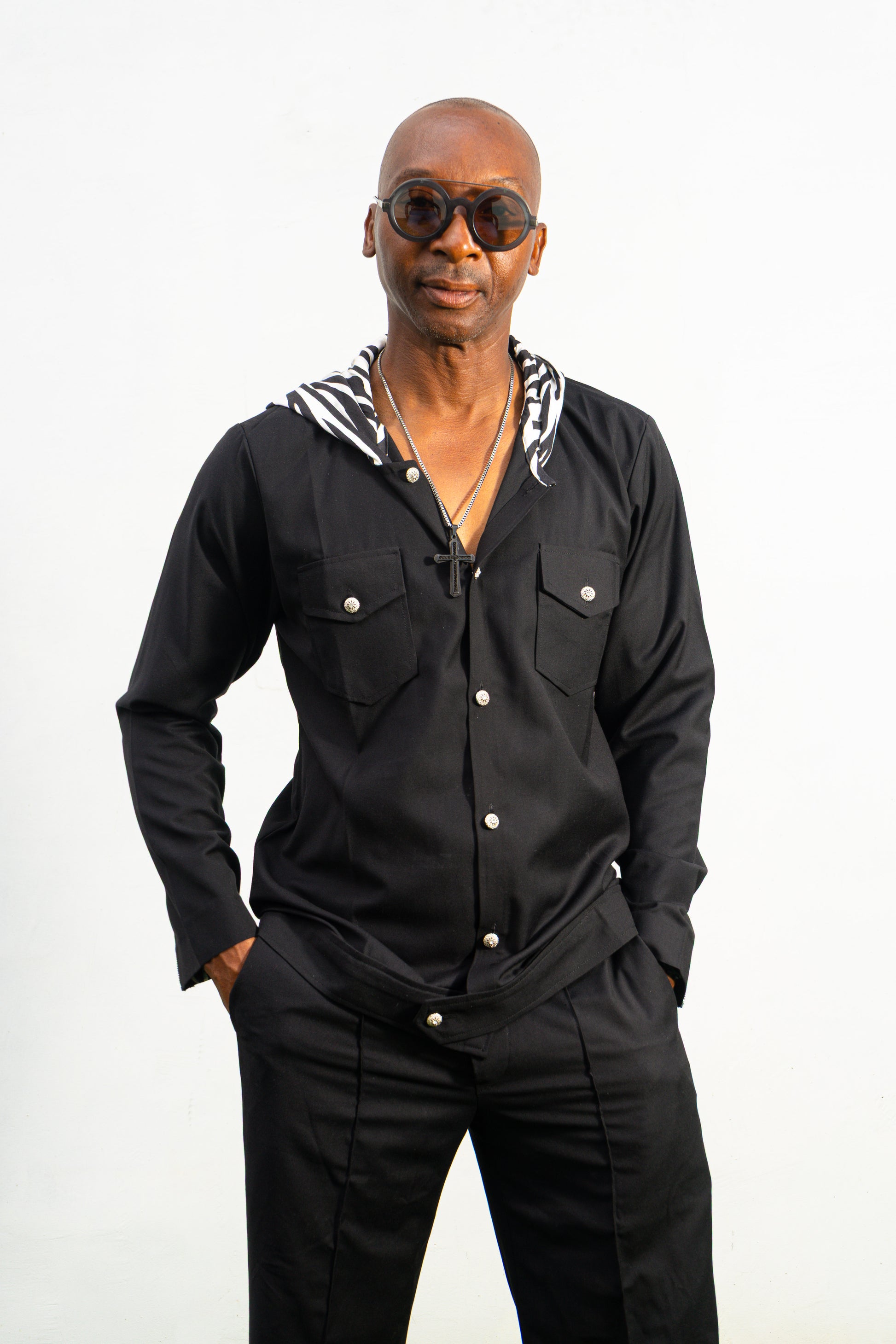 Two-Piece Set featuring a black hooded button-down shirt with zebra-print hood lining and matching black flared trousers with front-seam detailing.