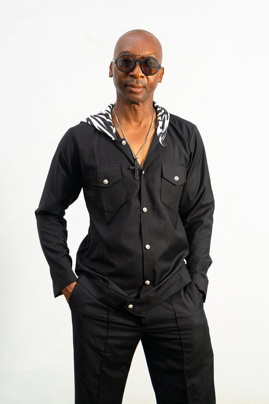 Two-Piece Set featuring a black hooded button-down shirt with zebra-print hood lining and matching black flared trousers with front-seam detailing.