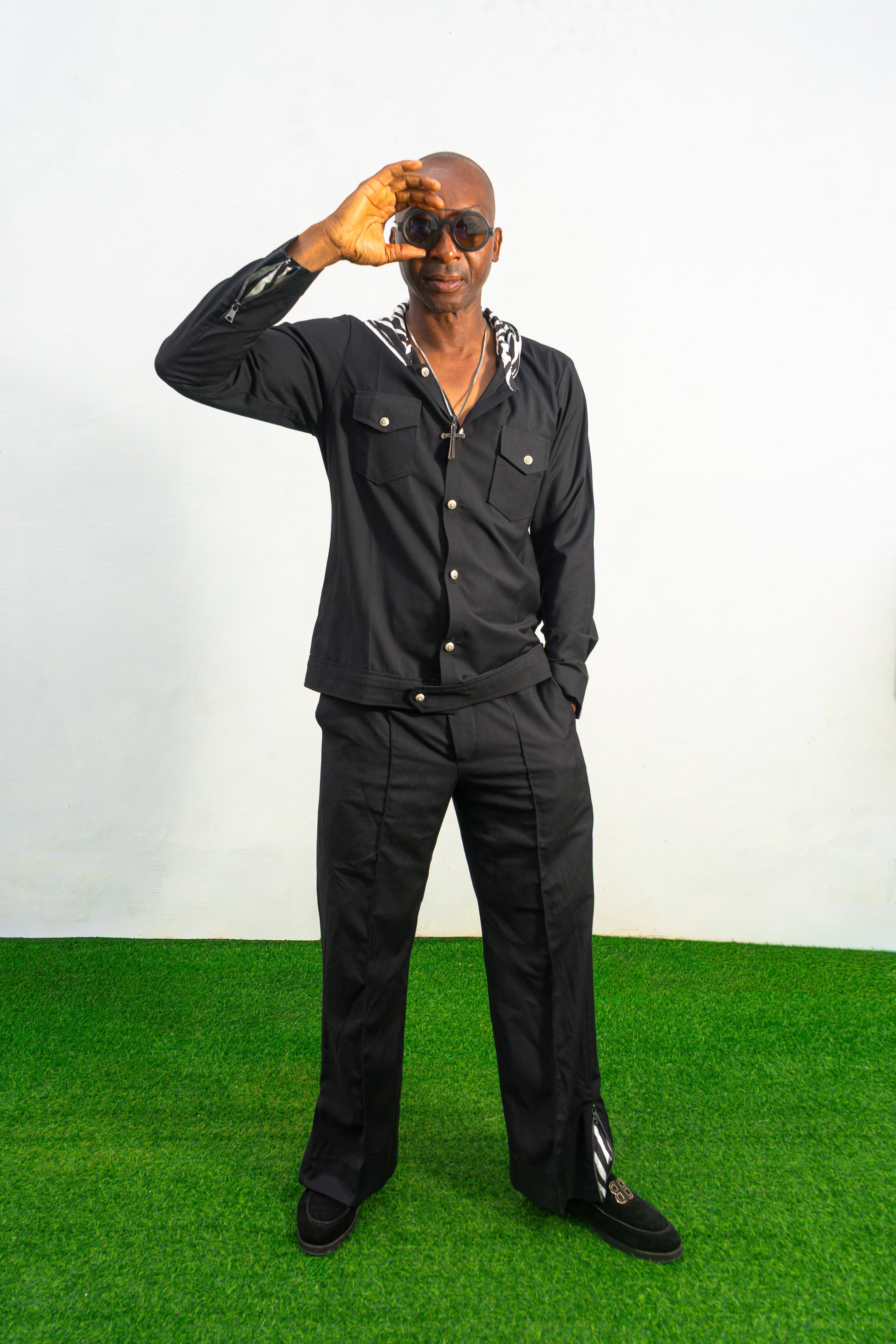 Two-Piece Set featuring a black hooded button-down shirt with zebra-print hood lining and matching black flared trousers with front-seam detailing.