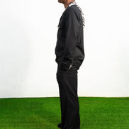 Two-Piece Set featuring a black hooded button-down shirt with zebra-print hood lining and matching black flared trousers with front-seam detailing.