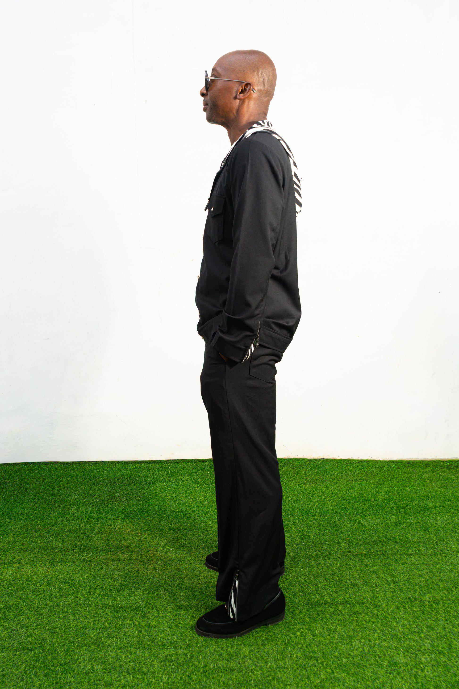 Two-Piece Set featuring a black hooded button-down shirt with zebra-print hood lining and matching black flared trousers with front-seam detailing.