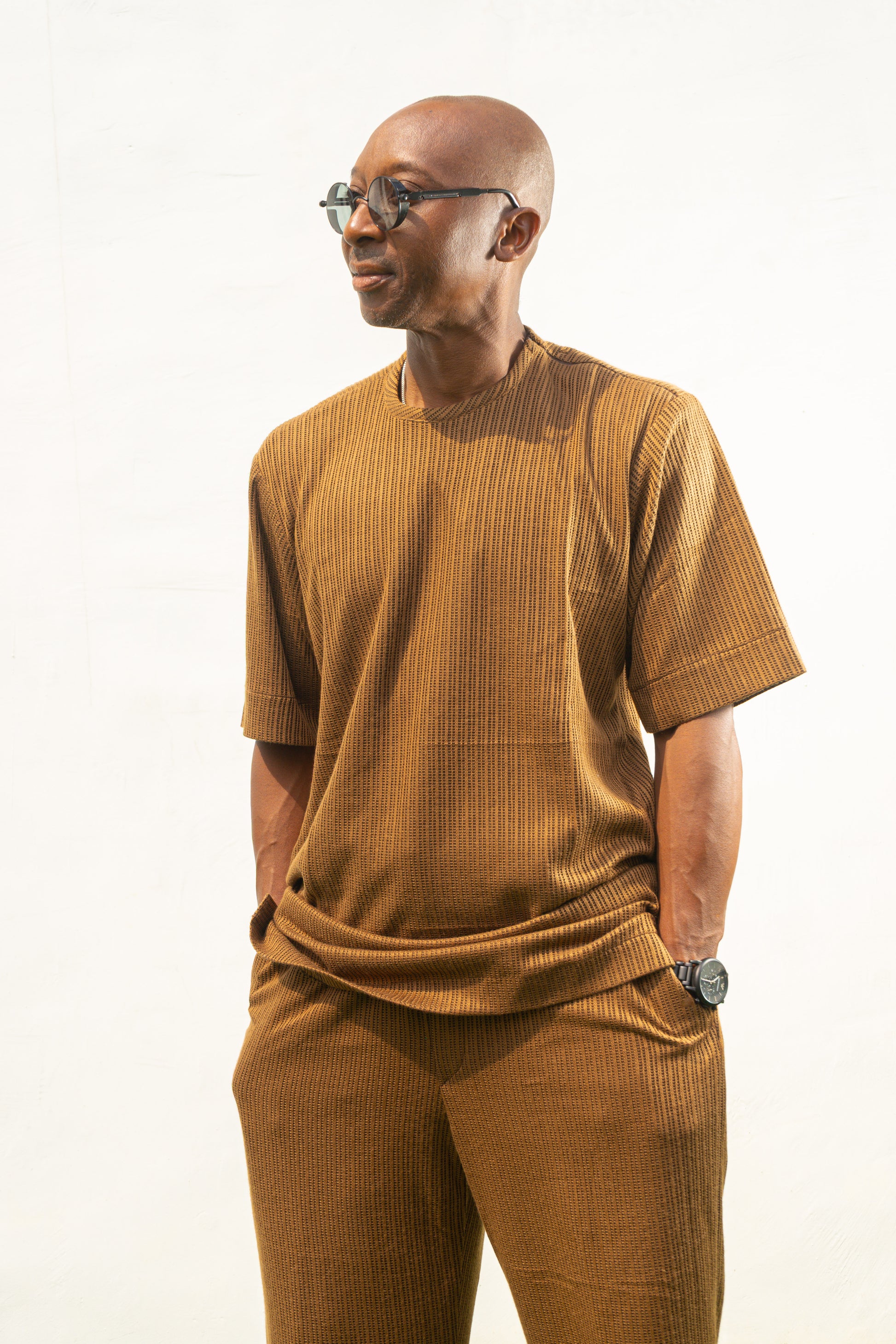 Two-Piece Set featuring a brown short-sleeved top and matching trousers in a textured weave with a simple crew neckline and relaxed silhouette.