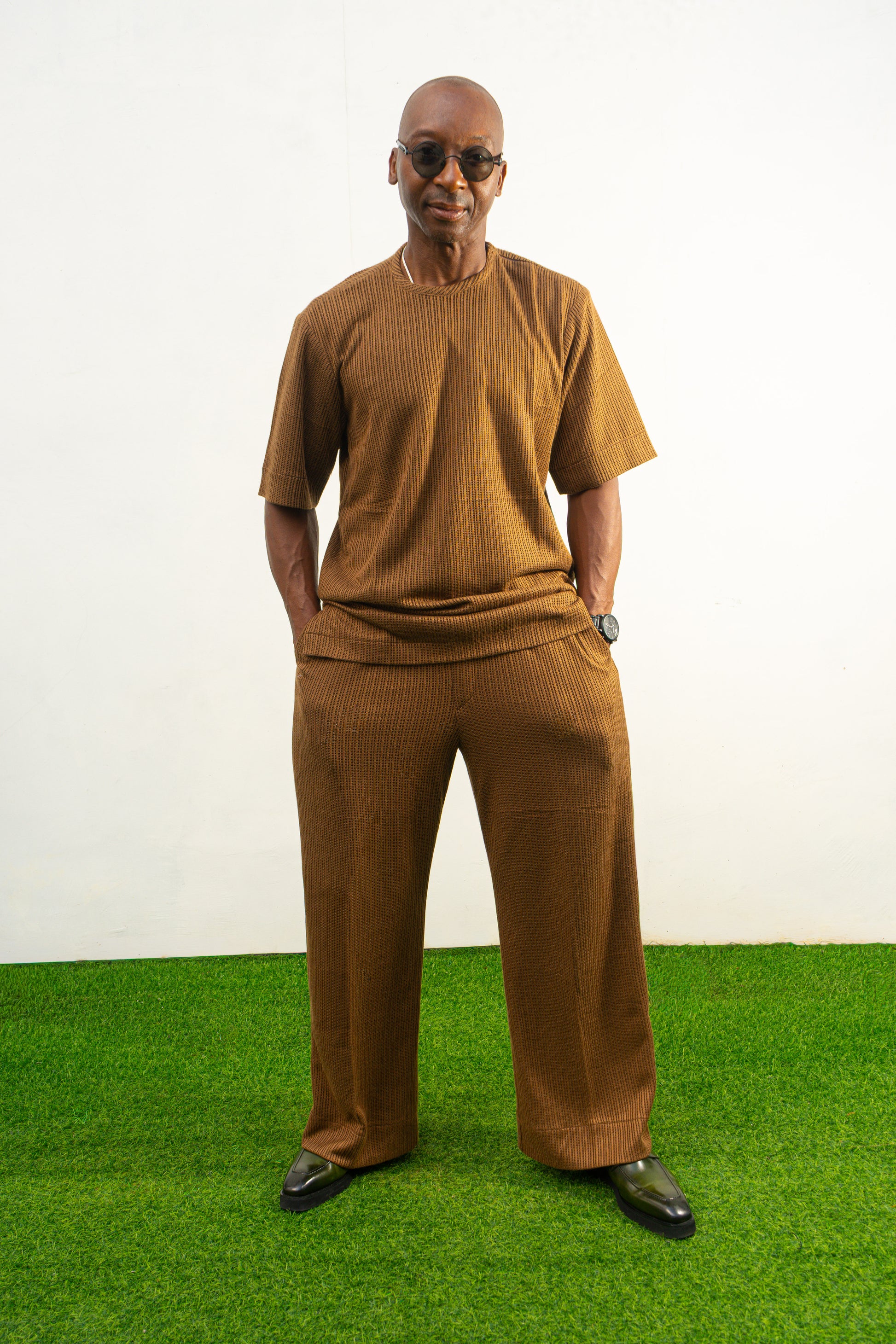 Two-Piece Set featuring a brown short-sleeved top and matching trousers in a textured weave with a simple crew neckline and relaxed silhouette.