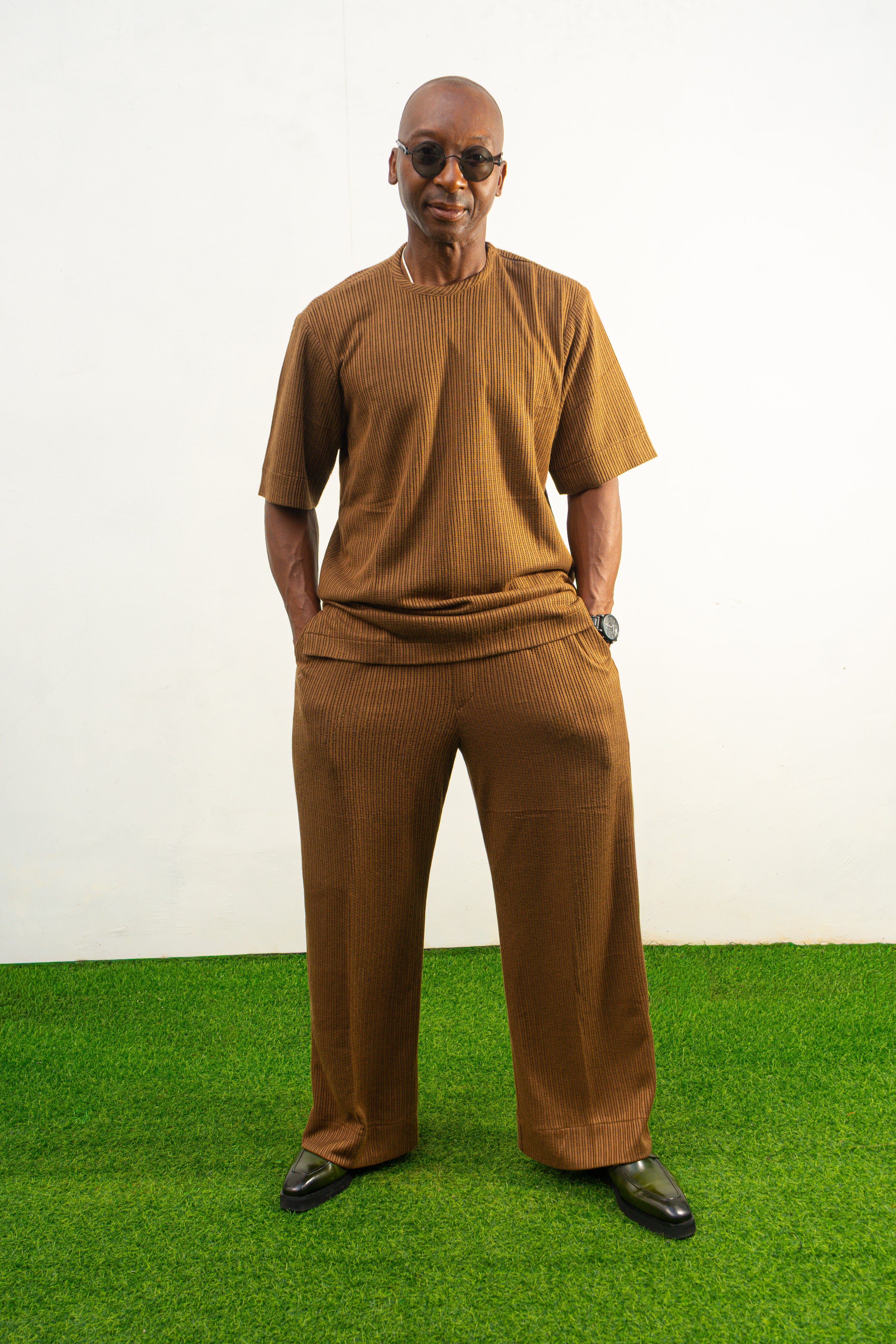 Two-Piece Set featuring a brown short-sleeved top and matching trousers in a textured weave with a simple crew neckline and relaxed silhouette.