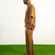 Two-Piece Set featuring a brown short-sleeved top and matching trousers in a textured weave with a simple crew neckline and relaxed silhouette. Side View